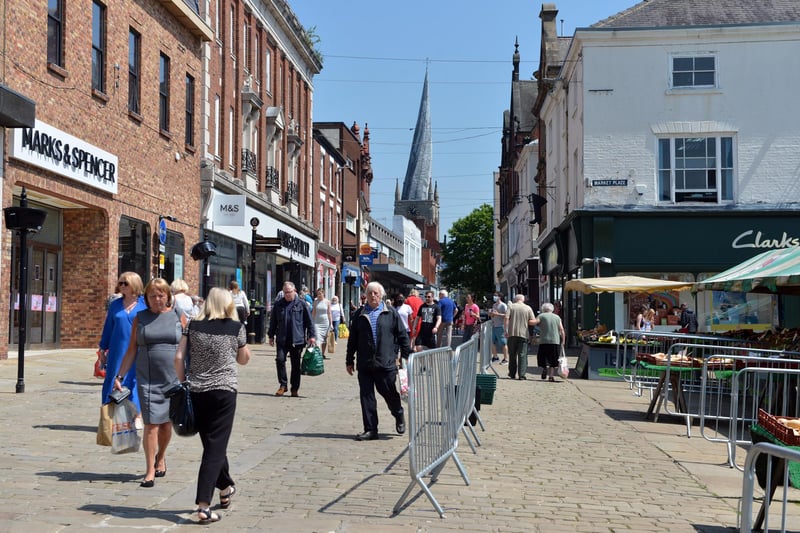 Shoppers enjoying a sunny Chesterfield, with the Crooked Spire and market looking a treat.
