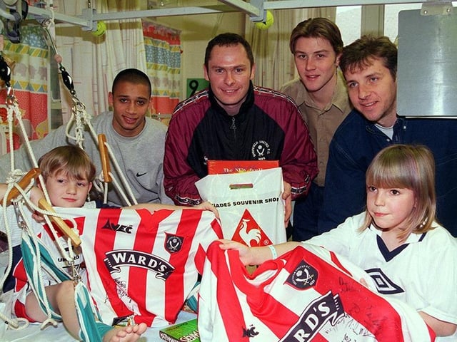 Sheffield United players, Curtis Woodhouse, Dane Whitehouse, Wayne Quinn and Simon Tracey, pictured handing out presents to patients Sam Chapman and Hayley Edge at the Sheffield Children's Hospital, on December 18, 1998