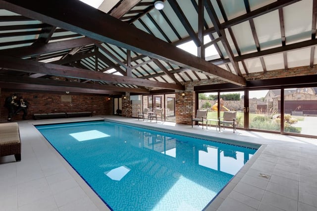 One of the most impressive features of the home is the indoor pool, fitted with panels opening to the rear garden.