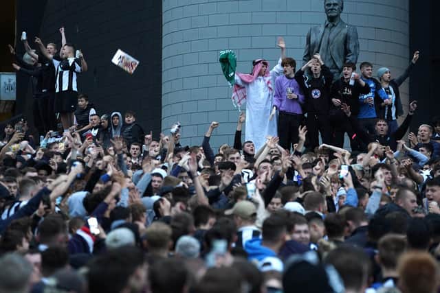 Newcastle United fans celebrate at St James' Park following the announcement that The Saudi-led takeover of Newcastle has been approved.  Owen Humphreys/PA Wire.
