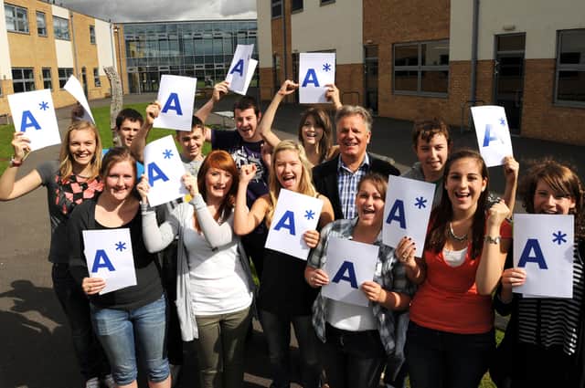 Headteacher Paul Buck pictured with pupils on results day for the last time before his retirement.