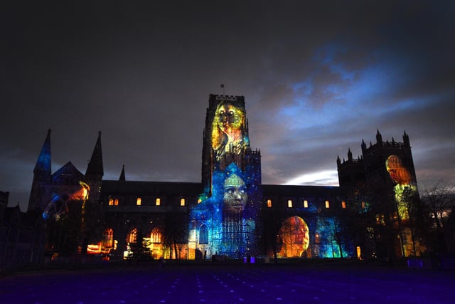 Durham Cathedral lit up against a brooding County Durham skyline with the "In Our Hearts Blind Hope" display by artist Zsolt Balogh, of Palma Studios.