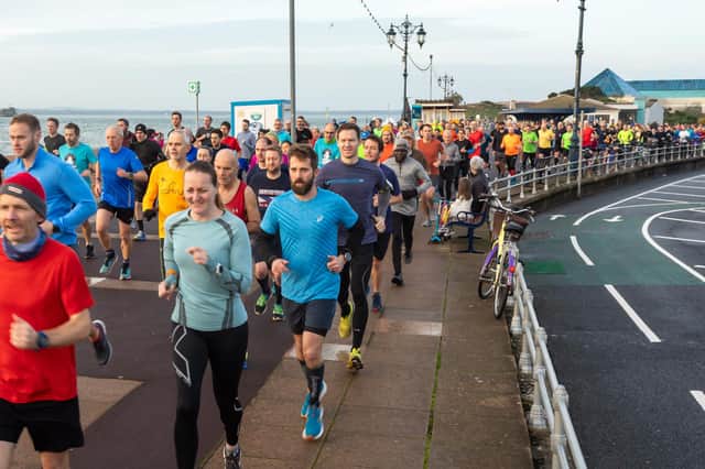 Runners form a long and vast line at the start of the New Year's Day Southsea parkrun. Picture: Mike Cooter (010122)