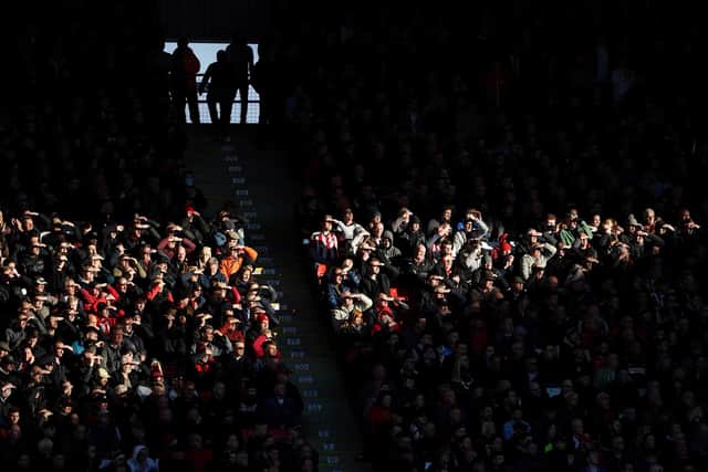 Sheffield United fans shield their eyes from sunlight as they watch their side in action against Coventry City at Bramall Lane: Zac Goodwin/PA Wire.