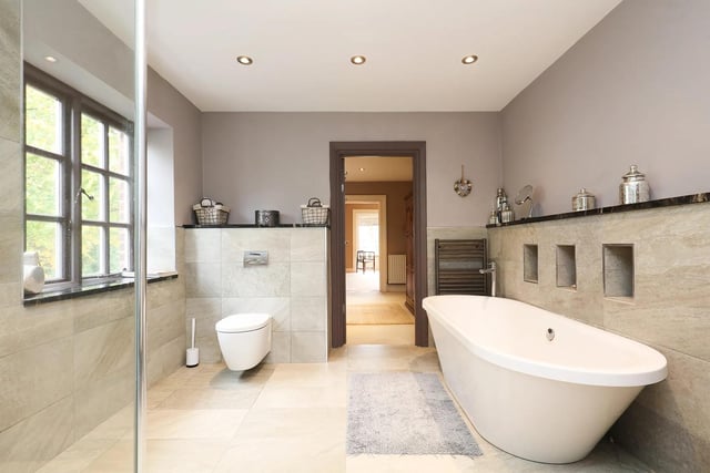 Light and bright, this bathroom has lots of space to relax.