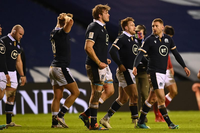 Finn Russell of Scotland (R) and teammates walk off the pitch following defeat during the Guinness Six Nations match between Scotland and Wales at Murrayfield