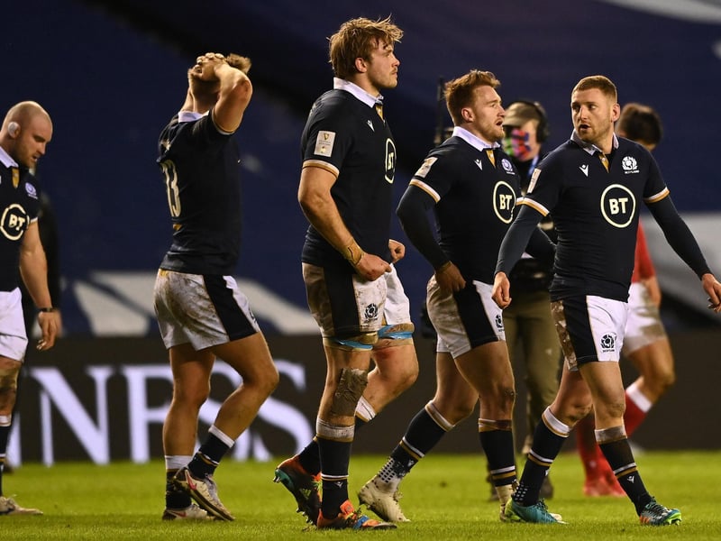 Finn Russell of Scotland (R) and teammates walk off the pitch following defeat during the Guinness Six Nations match between Scotland and Wales at Murrayfield