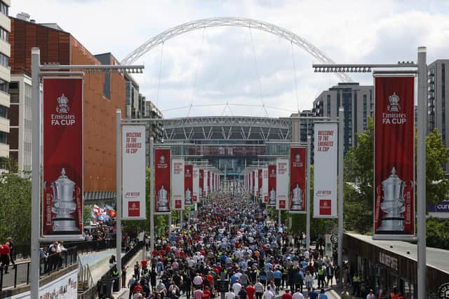 A man has been charged after he was seen wearing a football shirt at Wembley Stadium which appeared to make an offensive reference to the Hillsborough disaster.