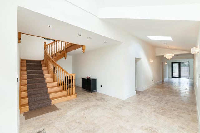 A spacious entrance hall with a staircase leading up to the first floor.