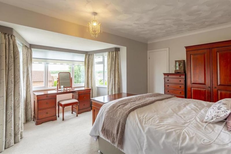 Another impressive bedroom, with its main focal point being a bay window. The fitted wardrobes add a touch of style.