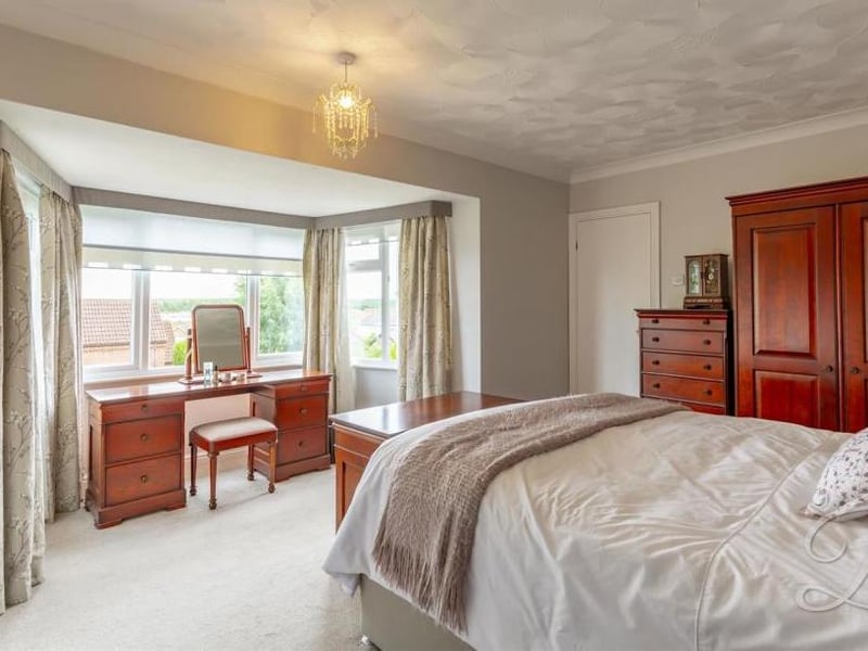 Another impressive bedroom, with its main focal point being a bay window. The fitted wardrobes add a touch of style.