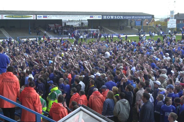 Fans invade the pitch on the last game of the season after winning promotion from Division Three.