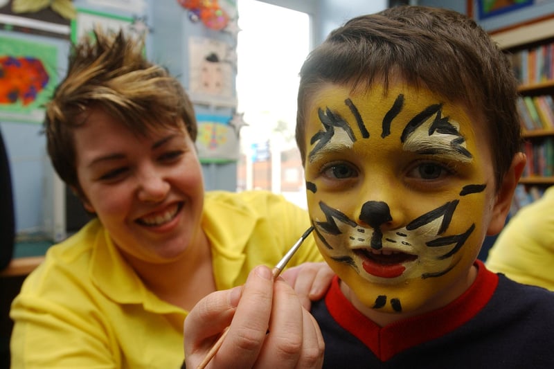 Library assistant Angela Purvis helps Joshua Biddell with face painting in this photo from 17 years ago.