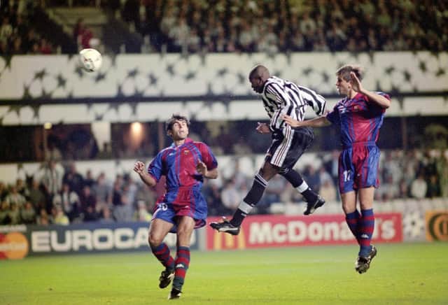 Newcastle United striker Faustino Asprilla leaps to head the third Newcastle goal and his hat trick goal during the UEFA Champions League match between Newcastle United and Barcelona at St James's Park on September 17, 1997 (Photo by Stu Forster/Allsport/Getty Images)