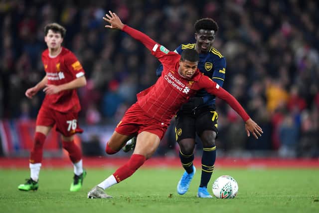 Rhian Brewster of Liverpool is challenged by Bukayo Saka of Arsenal (Photo by Laurence Griffiths/Getty Images)