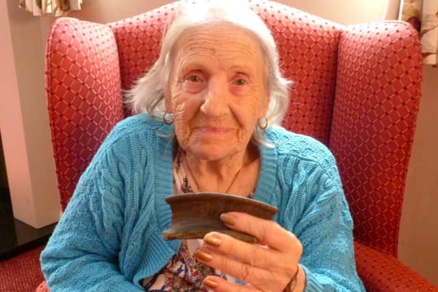 Dorothy Tomlinson, aged 91, with a piece of ancient Roman pottery