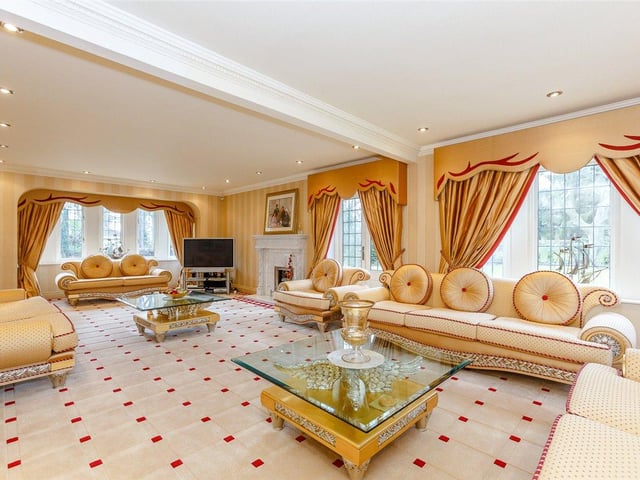 The vibrant lounge is extremely spacious, offering plenty of room for entertaining guests, and features a beautiful marble fireplace at its heart.