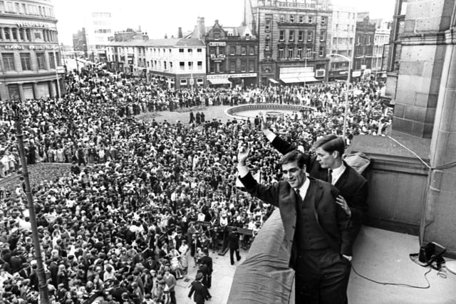 Wednesday players David Ford and Jim McCalliog wave to the crowds from Sheffield Town Hall balcony in May 1966.