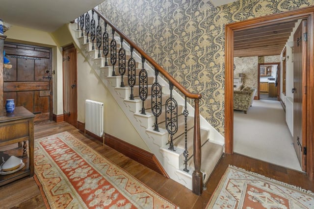The impressively wide staircase, with central carpet, stair rods, ornate cast iron balusters and original handrail, leads to the first floor.