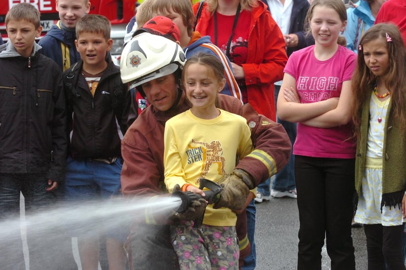 Children from Chernobyl who were visiting the city for a summer break learning firefighting skills at the fire service's Training & Development Centre at Handsworth. Elena Kukharevich has a go with a fire hose with with watch manager Pete Wood in July 2009