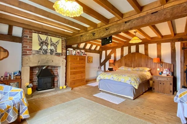 The third bedroom is large, with a feature stone fire surround and exposed brick chimney breast. It boasts fitted wardrobes and exposed beams to the ceiling.