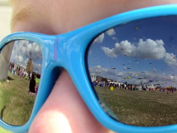 Taken on Saturday 23rd August 2014. Southsea Kite Festival reflected in the sunglasses of Alex Collins aged 4.