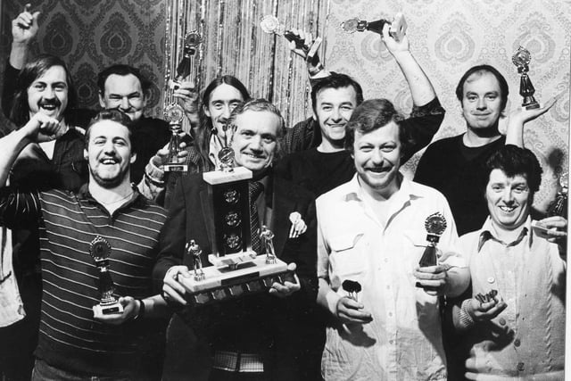 Roland Coyle, skipper of the Boldon Lad darts team, pictured with team members and their trophies at a social evening and presentation. Remember this from 1980?