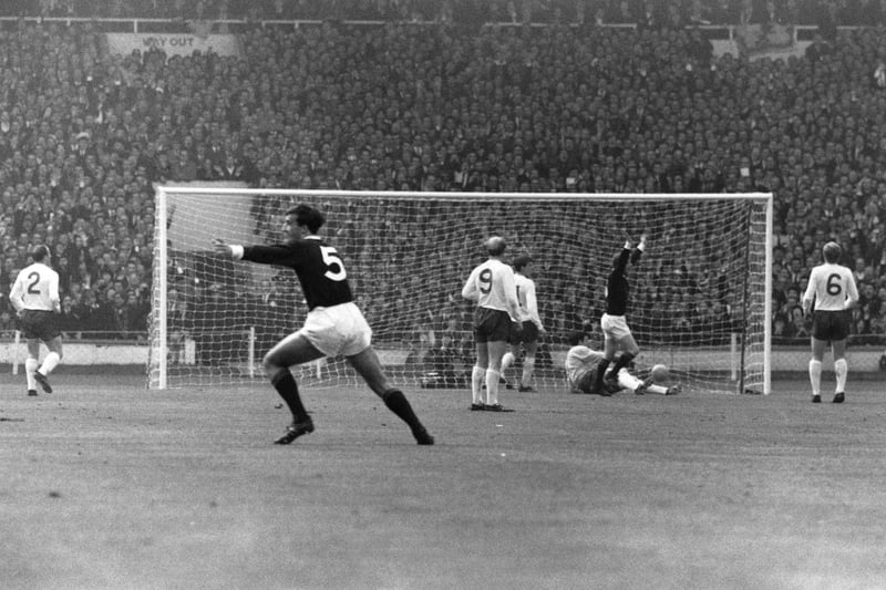Denis Law, second right, and Ron McKinnon (No.5) celebrate after Law opens the scoring for Scotland in their eventual 3-2 win over England at Wembley in April 1967