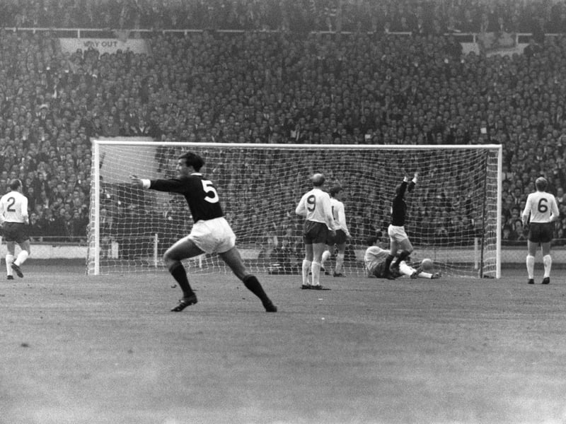 Denis Law, second right, and Ron McKinnon (No.5) celebrate after Law opens the scoring for Scotland in their eventual 3-2 win over England at Wembley in April 1967