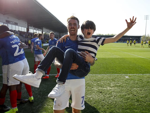 Tom Naylor carries a young fan while celebrating