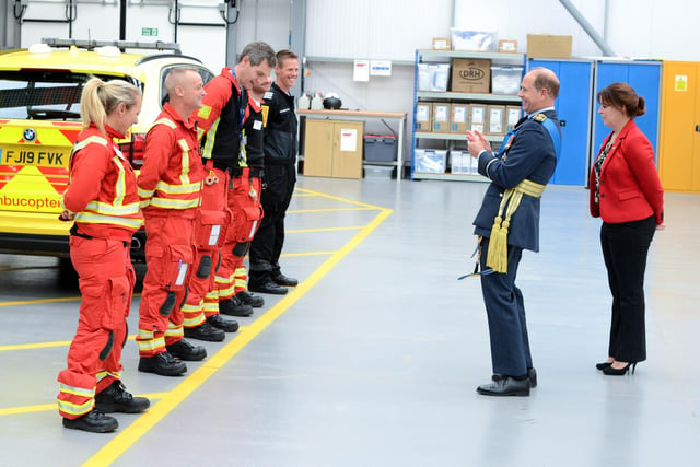 Prince Edward, Earl of Wessex, shares a joke with air ambulance staff.