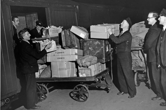 Packages are loaded onto a train at Sheffield Victoria Railway Station. Date unknown.