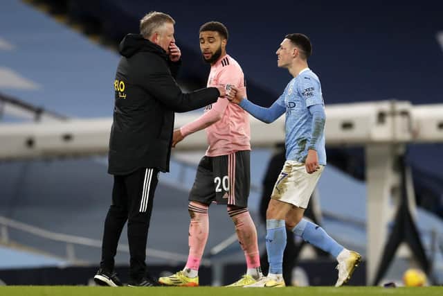 Phil Foden of Manchester City talks to Chris Wilder manager of Sheffield United after the Premier League match at the Etihad Stadium: Darren Staples/Sportimage