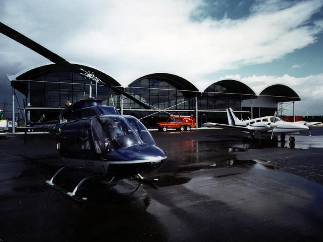 A helicopter outside the new terminal building at Sheffield City Airport