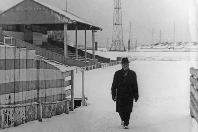 South Shields part-time groundsman Jimmy Crawford walks off the Simnonside Hall pitch after play in the scheduled South Shields v Scarborough Northern Premier League game was deemed impossible in 1968.