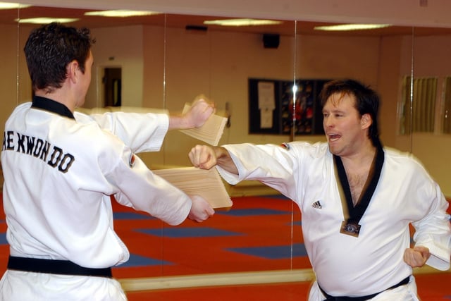 Master Andrew Blinston, of the Lynx Martial Arts Health and Fitness Centre, smashes a piece of wood, held by Andy Rogers, with his fist in 2003