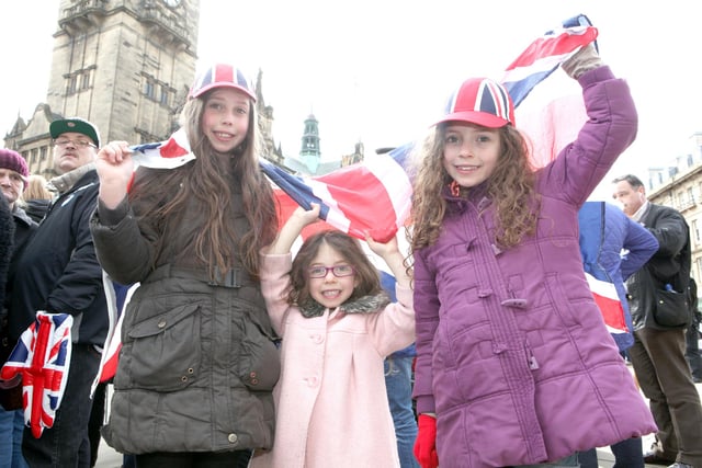 Sophie, Matilda and Evie Connor, aged 10, 4 and 8, from Sheffield, waiting near the town hall