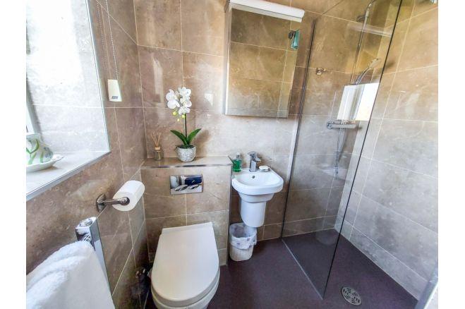 This bathroom feature a walk-in shower and is one of two bathrooms in the property.