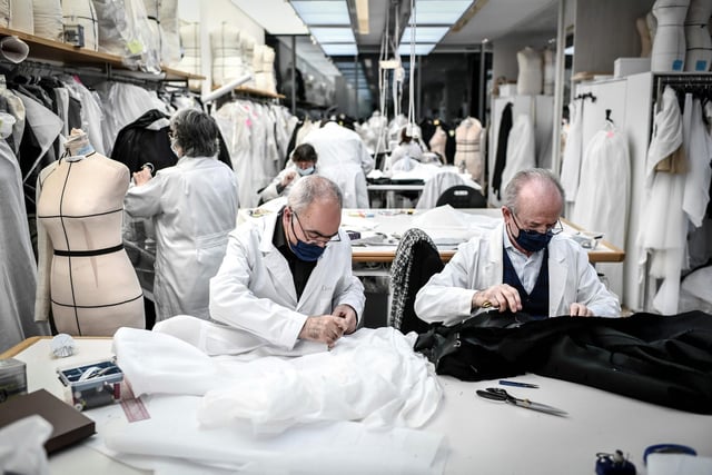 Employees work on couture garments