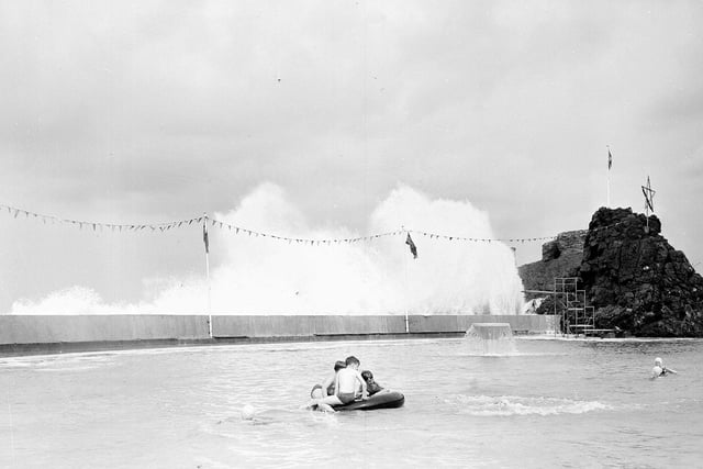 A wave breaks over Dunbar swimming pool  in July 1963.