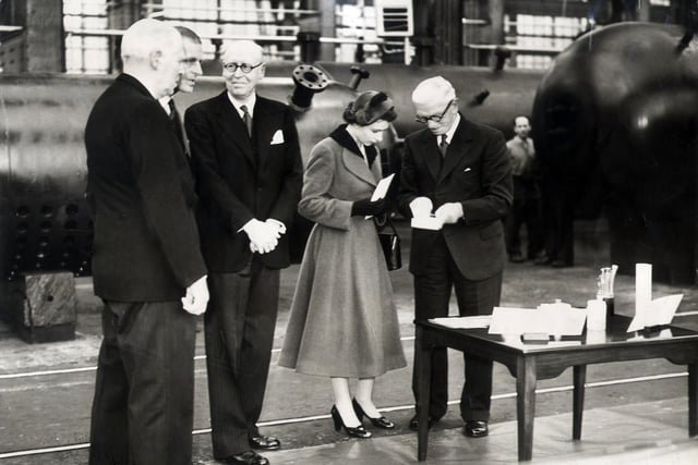The Queen and the Duke of Edinburgh are shown plastic articles which are made by the steel components in the shop at at E.S.C Sheffield on October 27, 1954
