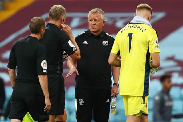 Sheffield United manager Chris Wilder speaks with Referee Graham Scott at the end of the first half during the Premier League match at Villa Park, Birmingham. Clive Rose/NMC Pool/PA Wire.