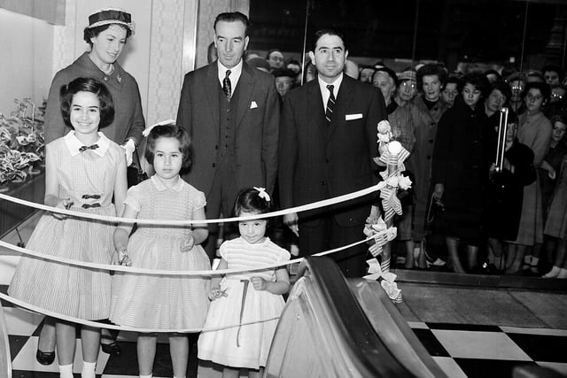 A new escalator at the Grant's Department Store is inaugurated by youngsters Jane, Marion and Rosemary Oppenheim in July 1959. It was the first escalator in Edinburgh and many people visited the store specially to ride on it.
