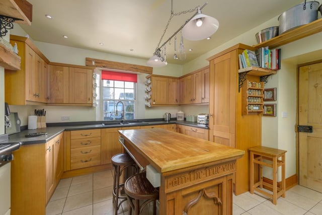 The kitchen has a fully tiled floor along with a range of wall and base units with a solid wood door. An inglenook space currently houses an AGA which is perfect for creating a warm space in the colder months.