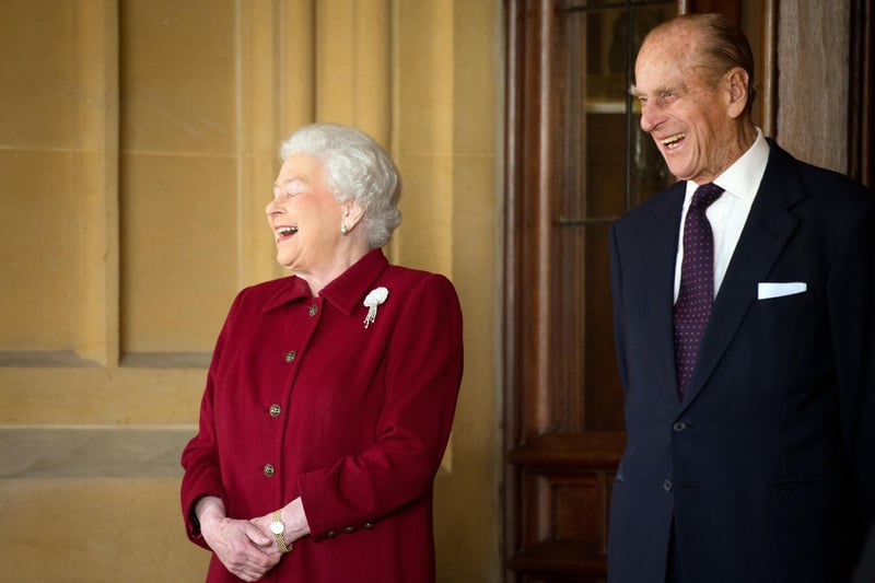Queen Elizabeth II and Prince Philip share a laugh together as they bid farewell to Irish President Michael D. Higgins and his wife Sabina at the end of their official visit at Windsor Castle in 2014 in Windsor, United Kingdom. (Photo by Leon Neal-WPA Pool/Getty Images)