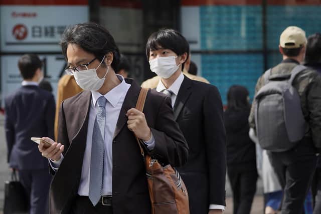 Pedestrians wearing face masks  (Photo by Toru Hanai/Getty Images)