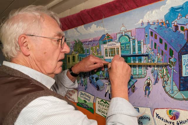 Artist Joe Scarborough working on his latest projects on his boat in Sheffield Canal Basin.