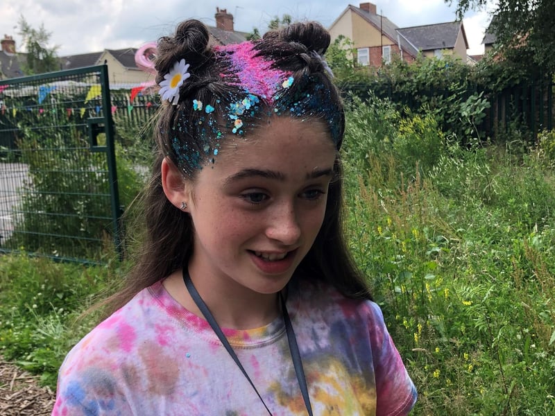 Rebecca Calladine from Saks hair salon treated pupils and teachers to festival style hair at Oak Fest at Our Lady of Sorrows Catholic Primary School