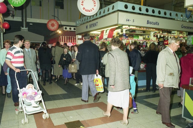 Crowds of shoppers at Jacky Whites Market in this year but which year is it?