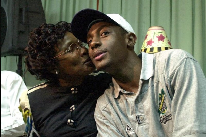 Russell Latapy gets a kiss from mum Joan after arriving back in his homeland
